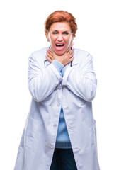 Wall Mural - Senior caucasian doctor woman wearing medical uniform over isolated background shouting and suffocate because painful strangle. Health problem. Asphyxiate and suicide concept.