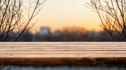 Poster - Empty wooden table showing a blurred sunset over city skyline