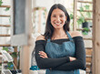 © CourtH/peopleimages.com - Waitress, woman and portrait with arms crossed at cafe for hospitality, confidence and ready for service. Happy barista, person and smile in coffee shop for small business management and welcome