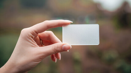 Woman hand hold a empty name card isolated