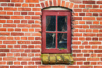 Old building, broken glass and window with brick wall in city, ghost town and abandoned house. Crack, home exterior and facade of vintage architecture with grunge graffiti, moss and poor property