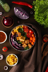 Wall Mural - Fried tofu salad on a wooden background