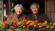 © Рудой Максим - Elderly couple sitting by a flower-filled window enjoying a sunny afternoon in their cozy home garden