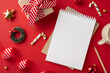 © ActionGP - Top view of a notepad surrounded by Christmas decorations and gift wrapping on a vibrant red background