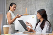 © bongkarn - An attractive Asian businesswoman is asking a question to her colleague while leading the meeting.