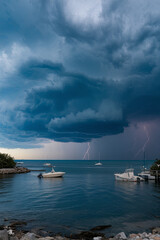 Fototapete - Severe storm clouds gathering over a coastal area, signaling extreme weather