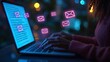 © pongtap - Person typing on laptop with email icons in a blurred background at night.