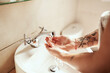 © Malambo/peopleimages.com - Water, woman and washing hands in bathroom for health protection, wellness and hygiene in home. Soap, person and cleaning palm in sink closeup for morning routine, skincare and bacteria prevention