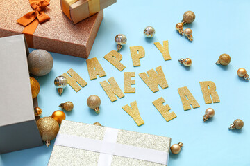 Text HAPPY NEW YEAR with Christmas balls and gift boxes on blue background