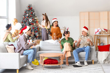 Poster - Group of friends with champagne celebrating New Year at home party