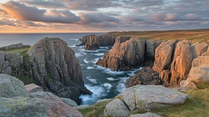 Dramatic cliffs and rocky coastline at sunset with a stormy sea.