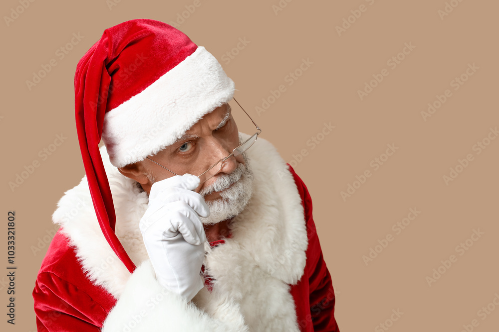 Suspicious Santa Claus in glasses on brown background