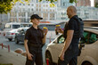 © Nomad_Soul - Diverse young two patrol police officers drinking coffee enjoying break rest
