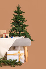 Wall Mural - Soft bench with Christmas presents and fir tree on brown background