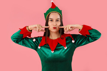 Poster - Beautiful young woman in elf's costume on pink background