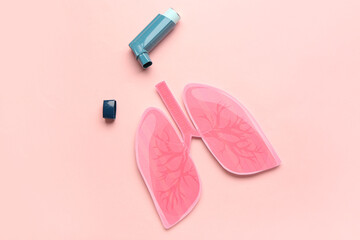 Wall Mural - Inhaler and paper lungs on pink background