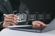 © Goodtime - E-library concept. Person use laptop with virtual E book icons for electronic books online, knowledge base on internet, digital library or e-library.