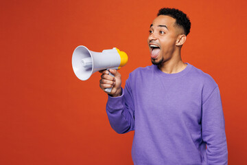 Poster - Young man of African American ethnicity wear purple sweatshirt casual clothes hold in hand megaphone scream announces discounts sale Hurry up isolated on plain red orange background Lifestyle concept