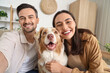© Pixel-Shot - Young couple with Australian Shepherd dog taking selfie at home, closeup