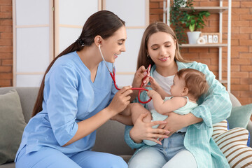 Poster - Female pediatrician with stethoscope listening to little baby and mother on sofa at home