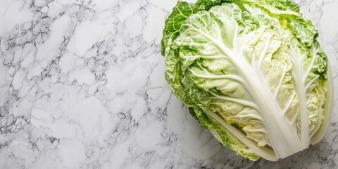 Canvas Print - A fresh head of Peking cabbage is diced to prepare a salad. Marble background.