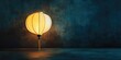 © HN Works - Vietnamese or Chinese round white lantern illuminated against a dark, vintage concrete background with copy space in landscape orientation.