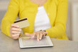 © auremar - woman using a credit card and digital tablet