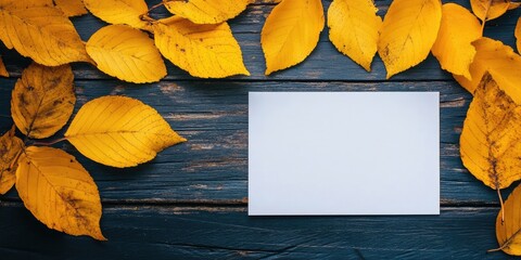 Poster - Yellow leaves on a wooden background in autumn with white paper for copy space, colorful mock-up.