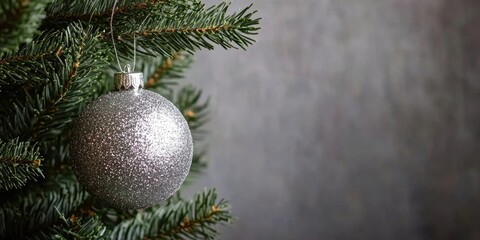 Leinwandbilder - Christmas ball with glitter hanging on the Christmas tree for decoration during Christmas or New Year's Eve. There is an area for the copyspace.