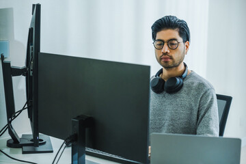 Wall Mural - asian man prompt engineer develop coding app with software data sitting in front of computer monitor