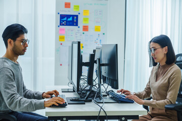 Wall Mural - asian woman and indian man developer team working about programming software data online at office