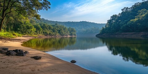 Poster - A rural Indian river lake features an empty beach alongside forested hills with trees, sandy areas, rocks, stones, and reflections on the water, providing copy space.