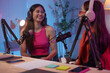 © crizzystudio - Two beautiful women chat while co-hosting an audio broadcast in a home studio. Recording internet podcasts for social media channels Ideas for creating online work.