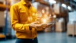 © Pojjanee - Logistics Management: A warehouse worker uses a tablet to manage inventory and logistics, showcasing modern technology in supply chain operations.