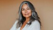 © Robert Kneschke - Portrait of a pleased Native American woman in her 40s with gray hair and a warm smile wearing a cozy white sweater