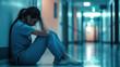 © smth.design - Exhausted nurse sitting in hospital corridor feeling overwhelmed and stressed