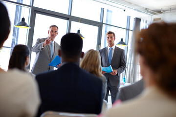 Poster - Meeting, speaker and men with business people in conference, tradeshow and presentation. Corporate manager, professional audience and workers in office for seminar training, workshop and convention