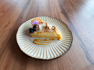 beautiful premium lemon cheese cream milk layer baked tart cake with blueberry flower 3d shape in plate on wood table halal asian sweet dessert food menu western cafe pastry restaurant