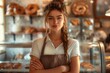 © Oksana - Young woman in apron standing in bakery with arms crossed. Indoor portrait for bakery and small business design.