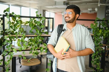 Happy indian male student at the university