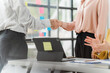 © Kritdanai - Business Deal Sealed: A handshake signifies a successful business deal, with the background of a modern office brimming with creativity and collaboration. This image conveys trust, partnership.
