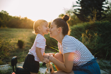 Toddler girl is playing with her mom