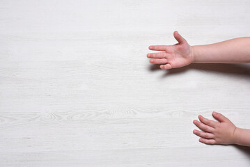 Children hands on the white table background with copy space. Top view.