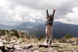 © ADDICTIVE STOCK - Young woman celebrates hiking achievement in scenic Cumbres del Ajusco