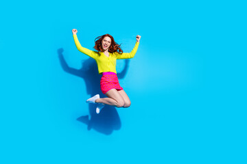 Canvas Print - Full length photo of lovely young lady jumping winning dressed stylish yellow garment isolated on blue color background