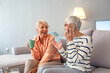 © Dragana Gordic - Happy Senior Women Laughing Together on a Comfortable Sofa
