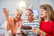 © Dragana Gordic - Joyful Senior Women Celebrating Birthday with Cake and Candles
