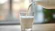 © ctrlaplus - Pouring fresh milk from bottle into glass at wooden table in the cozy room.