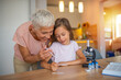 © Dragana Gordic - Grandmother and Granddaughter Conducting Fun Science Experiment at Home