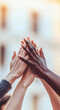 © IBEX.Media - Hands of diverse individuals coming together in unity, symbolizing teamwork, inclusivity, and cooperation, representing global diversity and community